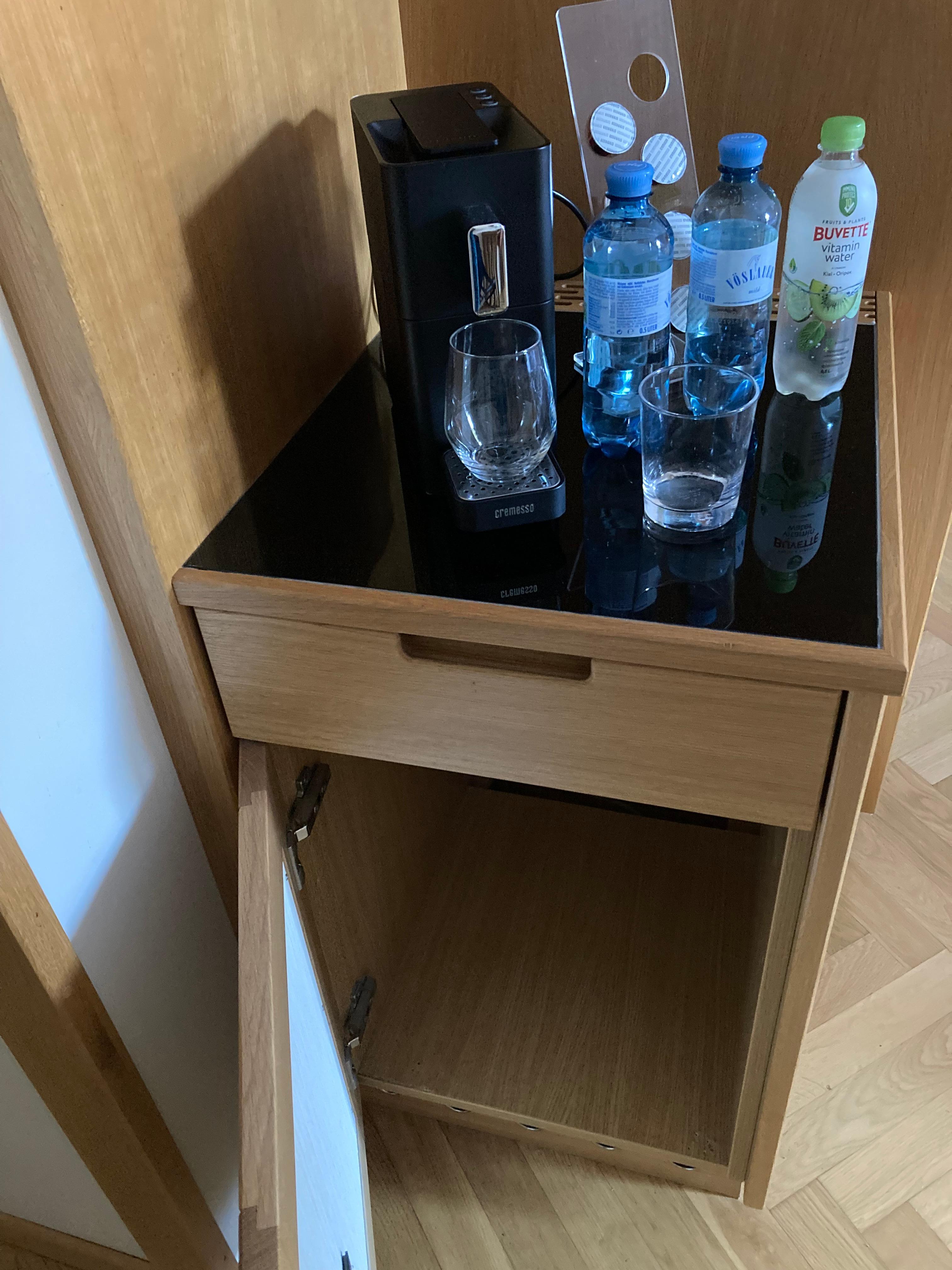 Empty fridge cabinet. No cups for coffee. 