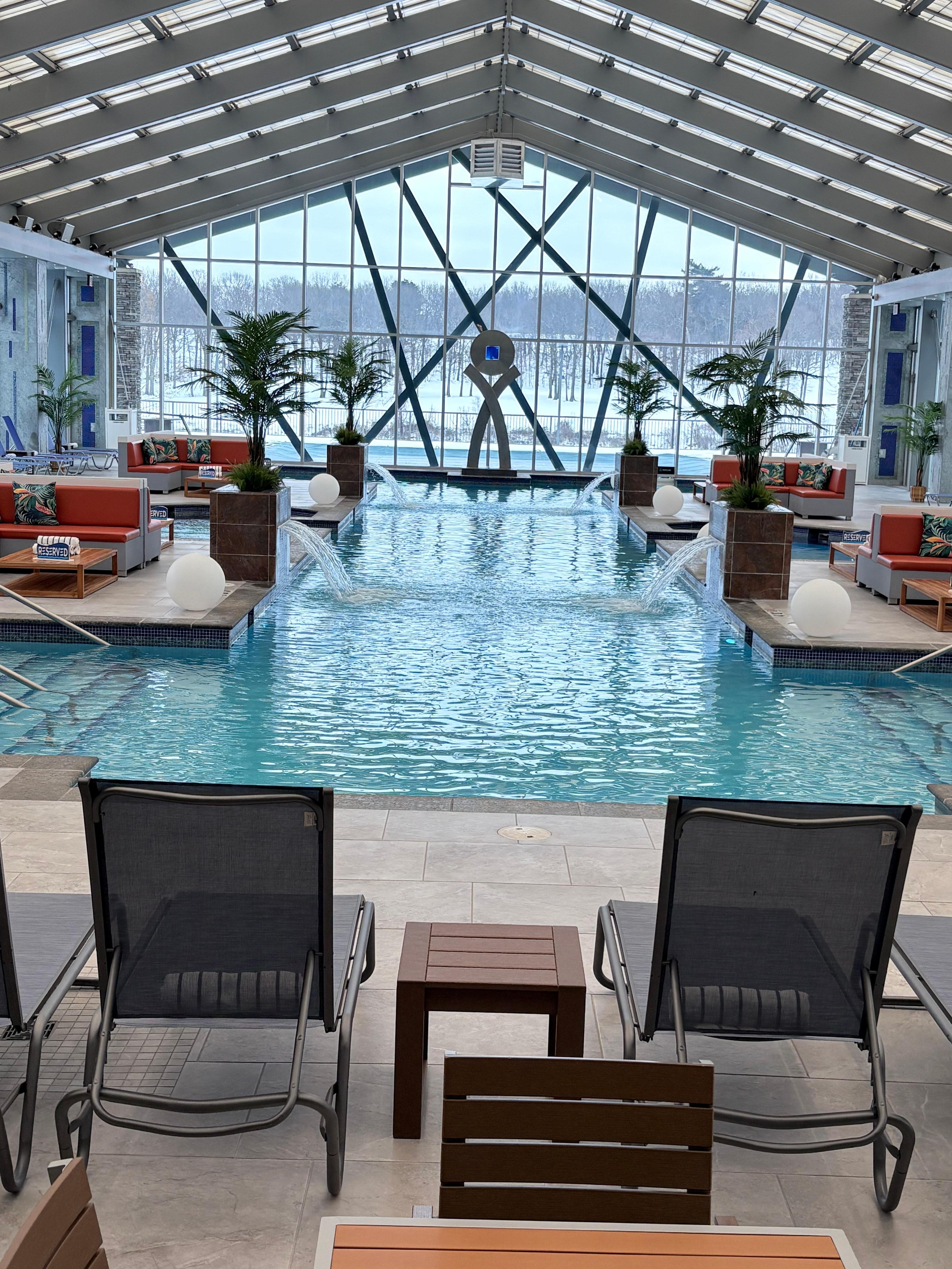 Indoor pool area with a bar area 