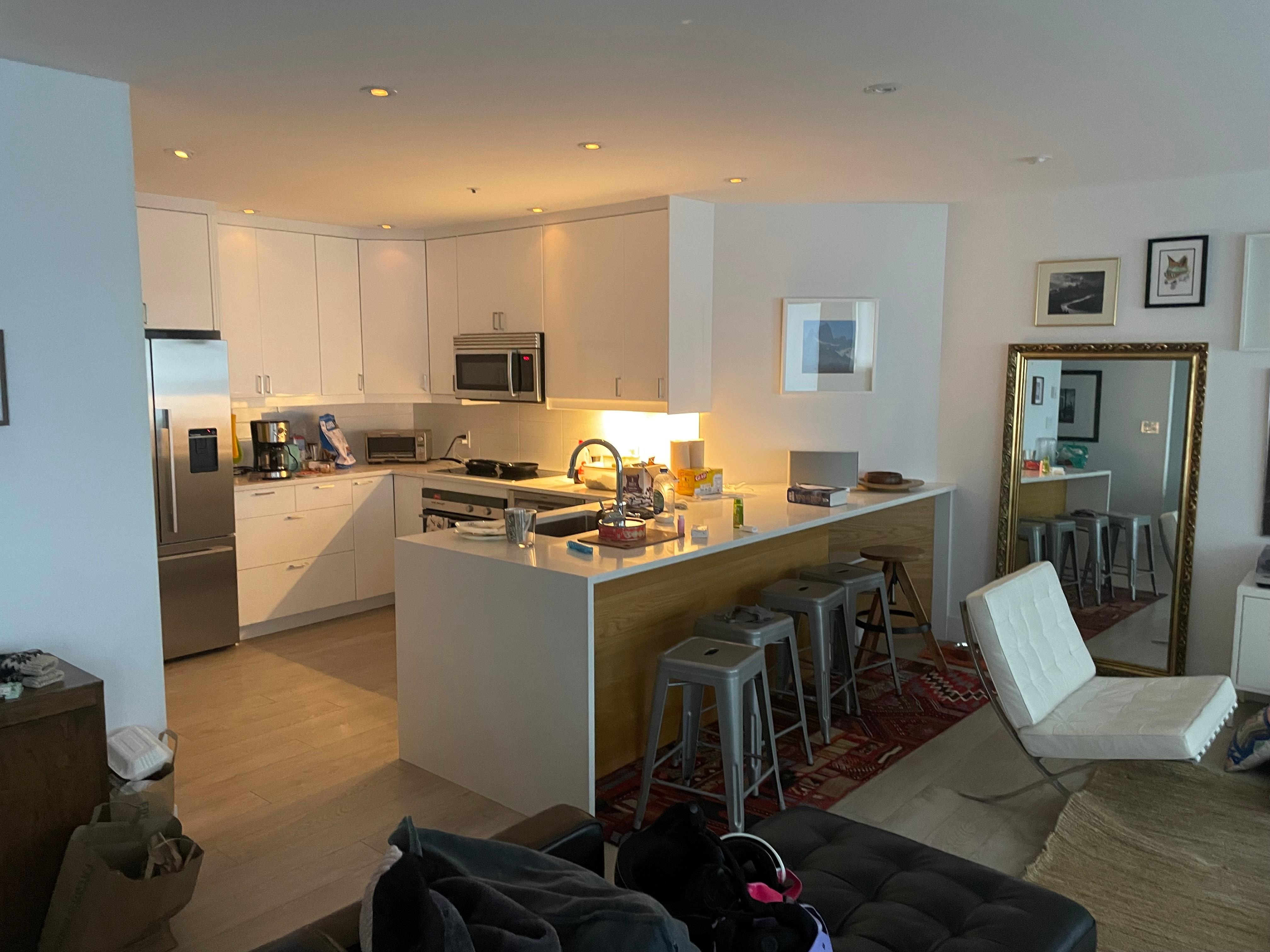 Kitchen with living room and dining room next to it