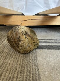 Bed broken. Propped up by a stone?!