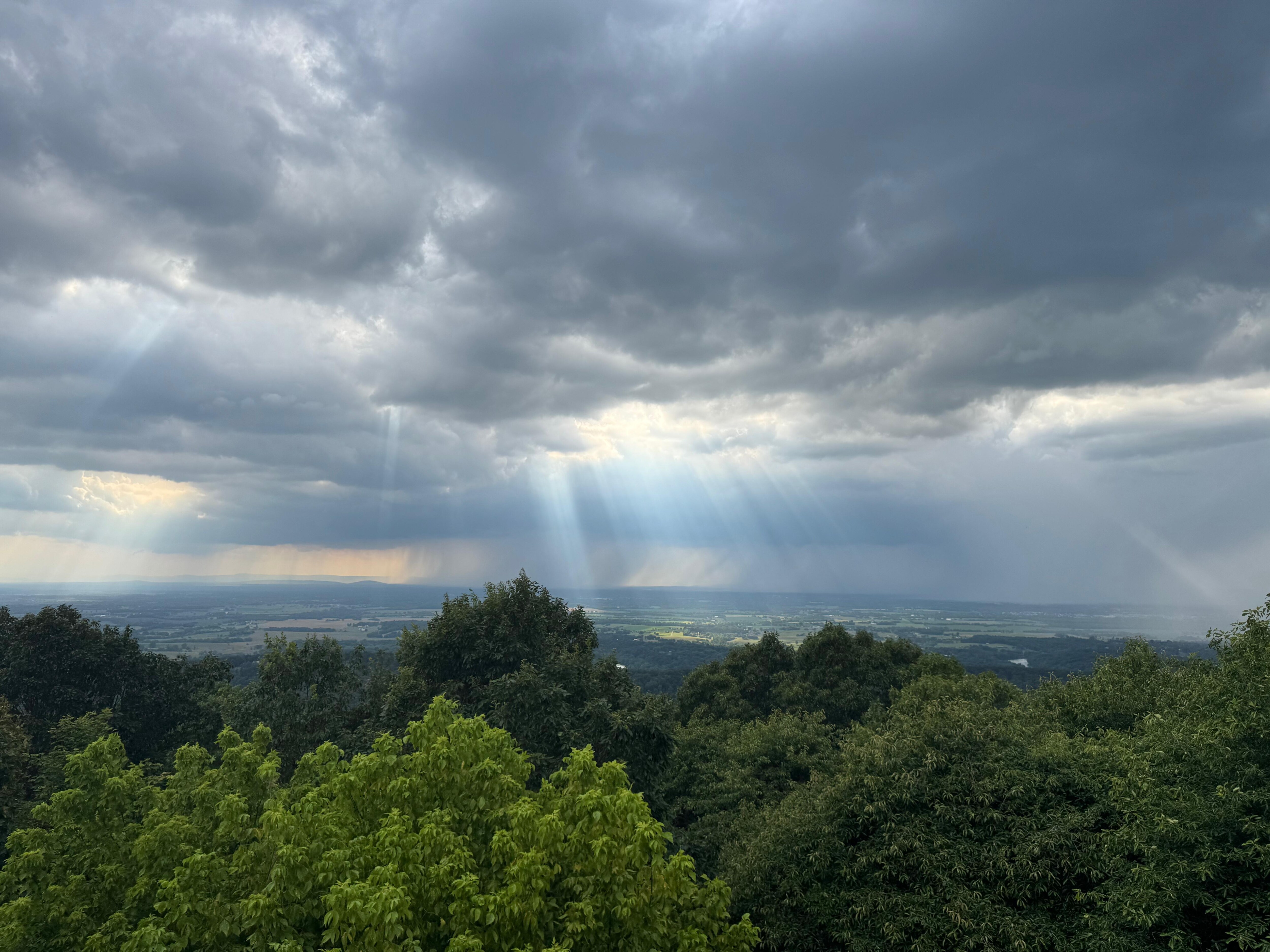 View from the balcony, with sunlight peeking through stormy skies. 