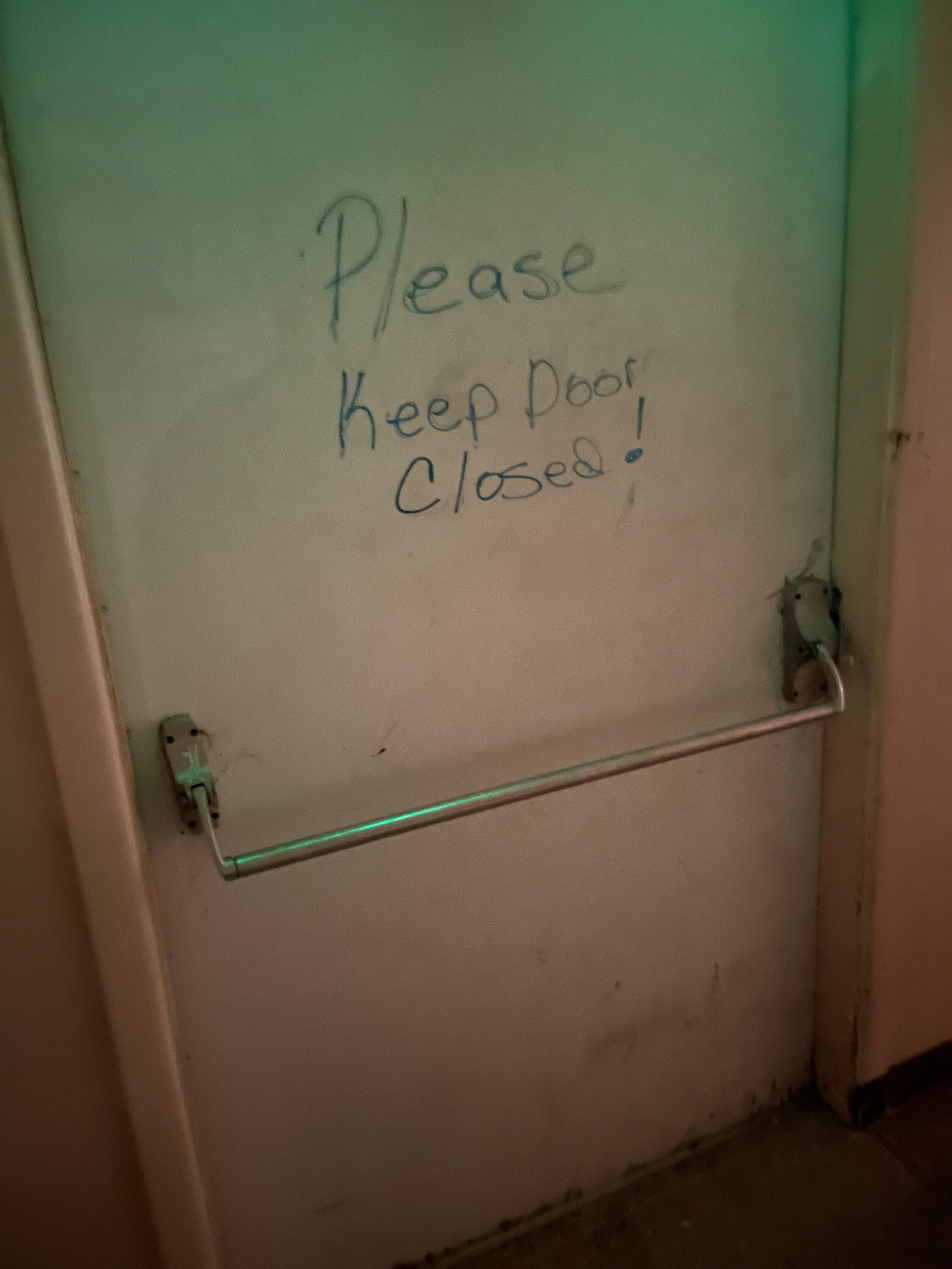 Door to outside with written note to keep closed