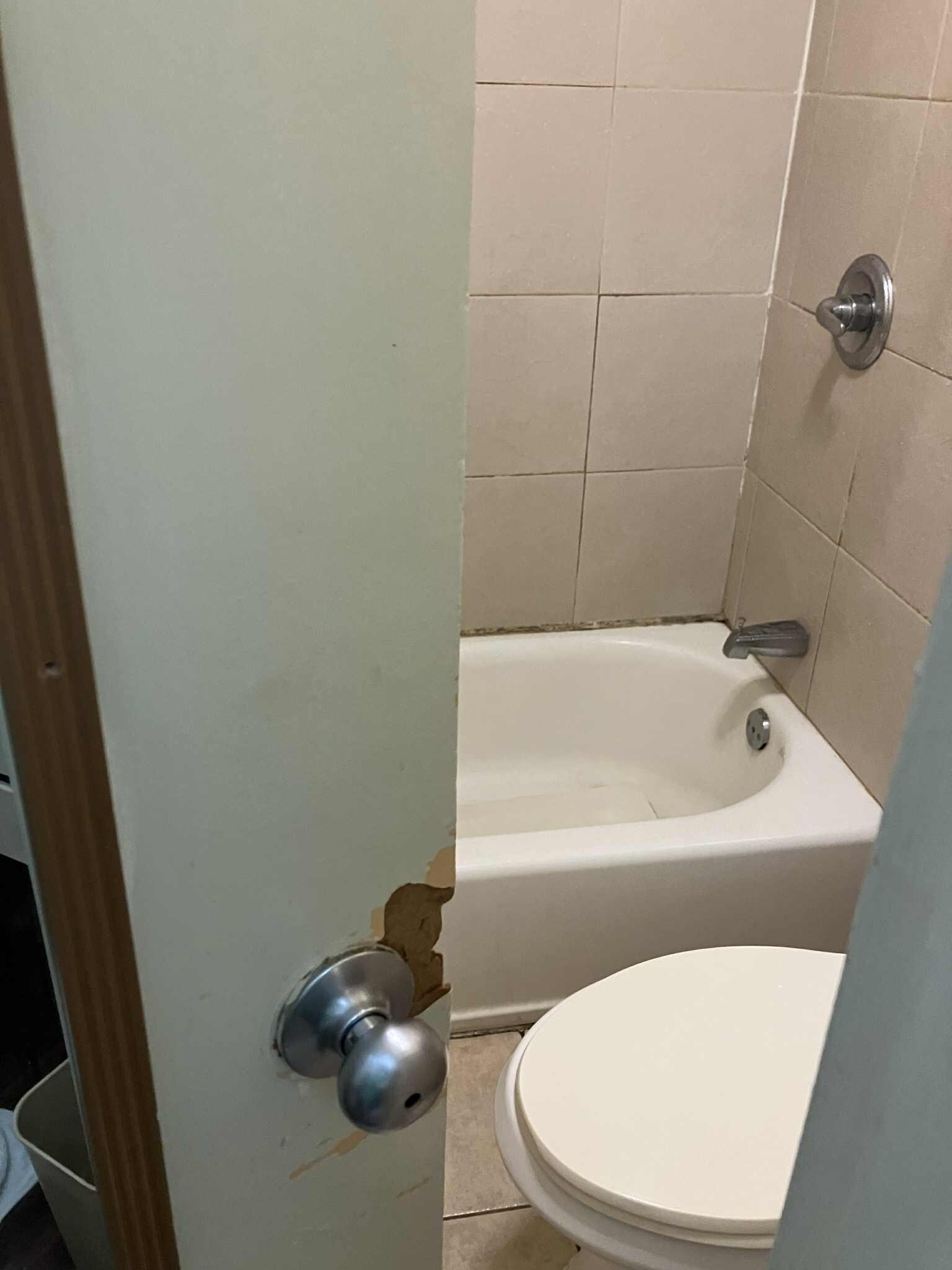 Bathroom door broken from a forced entry.