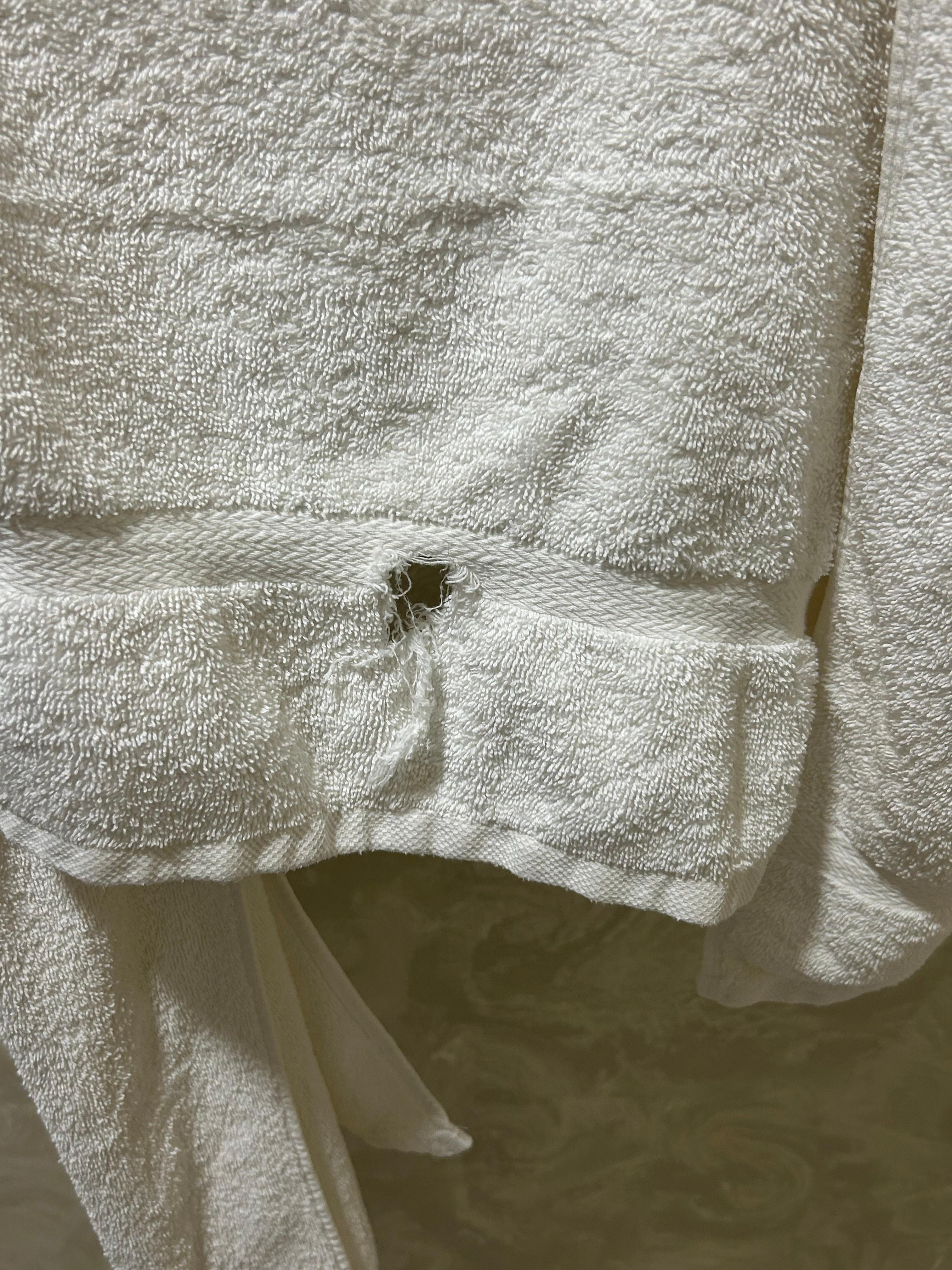 Holes in towels and “white” towels were brownish and stained