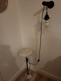 small unstable table, lights hanging from their cords.