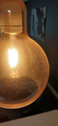 Dusty pendant lights above kitchen bench top.