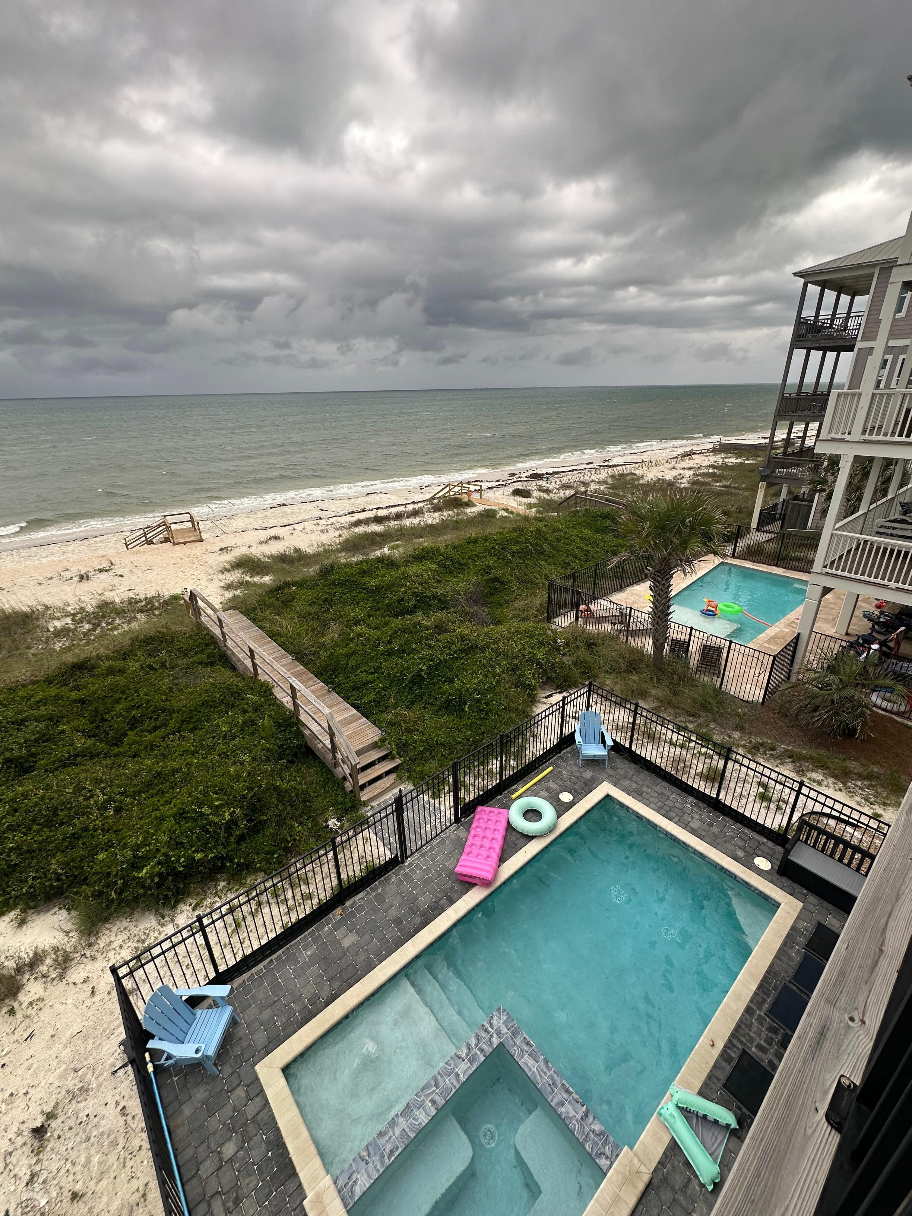 View from the balcony- pool, ocean, and private path to the beach