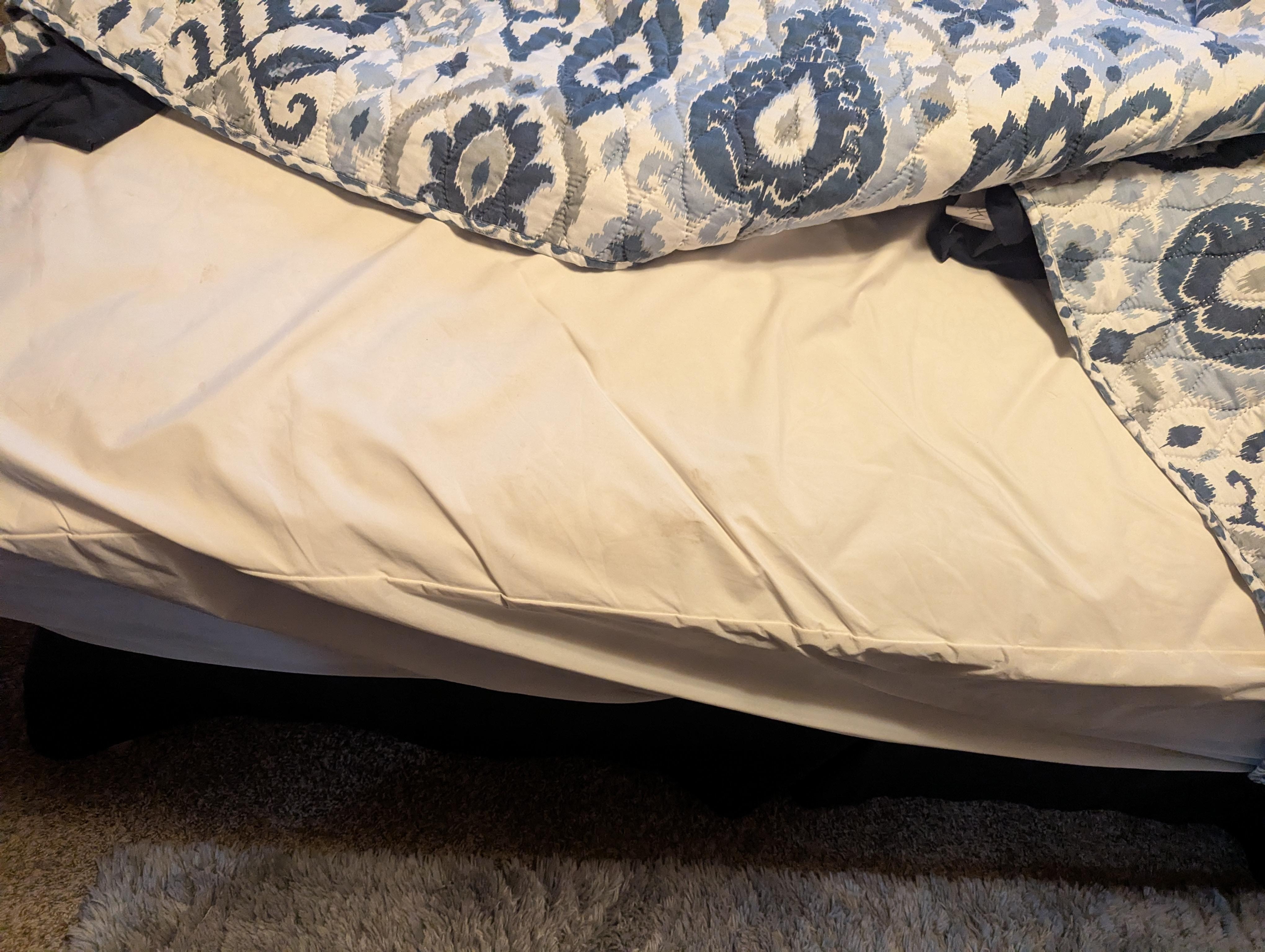 Worn thin mattress with dirty mattress cover