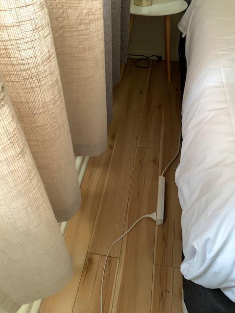 No power points in room near bed. Extension cable and board for power.