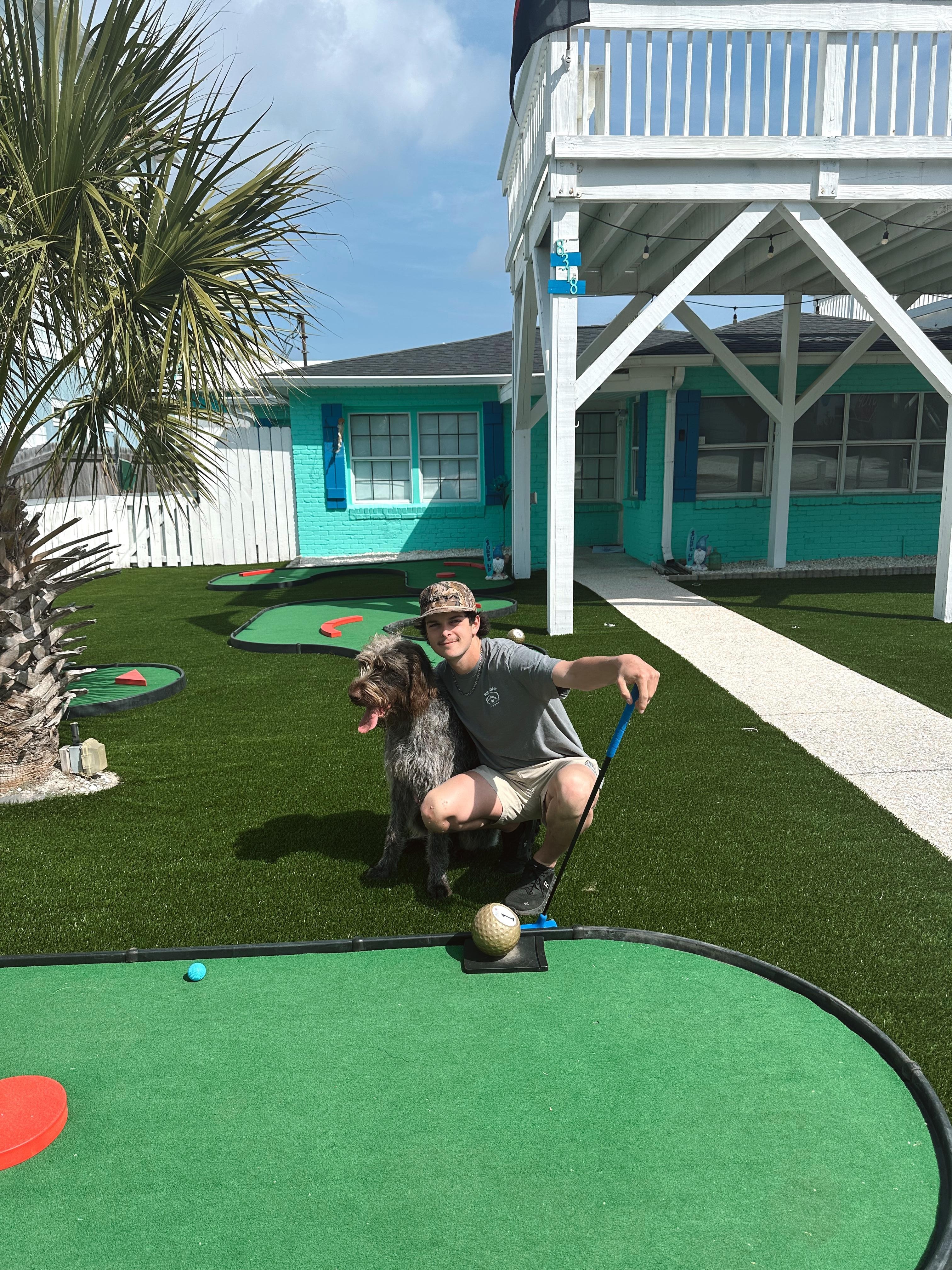 Tyler and Otis playing some afternoon putt putt