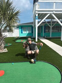 Tyler and Otis playing some afternoon putt putt