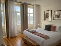 River View Balcony Apartment, bedroom toward the bedroom’s balcony.