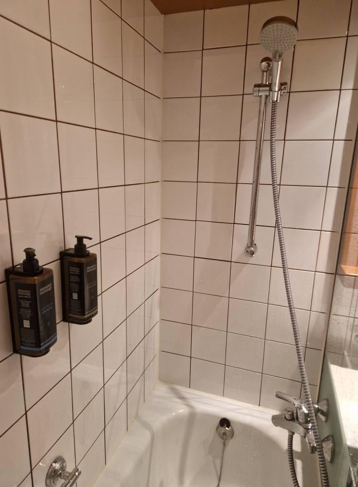 Unable to use shower, Becomes very slippy, you cant stand under it unless your very short.
