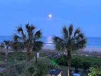 The moon reflects on ocean.
