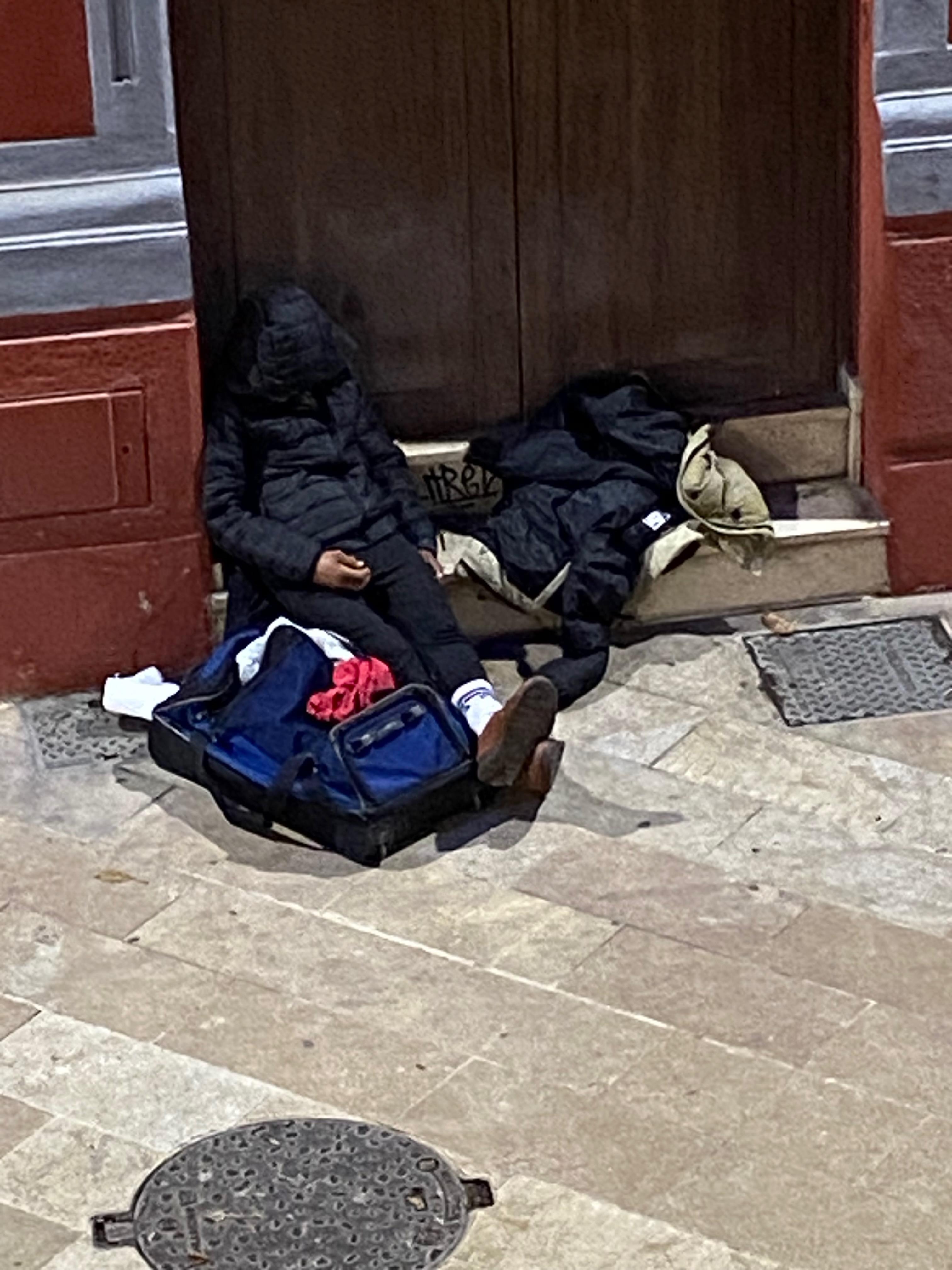 Homeless person sleeping in the door way