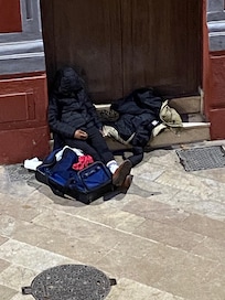 Homeless person sleeping in the door way