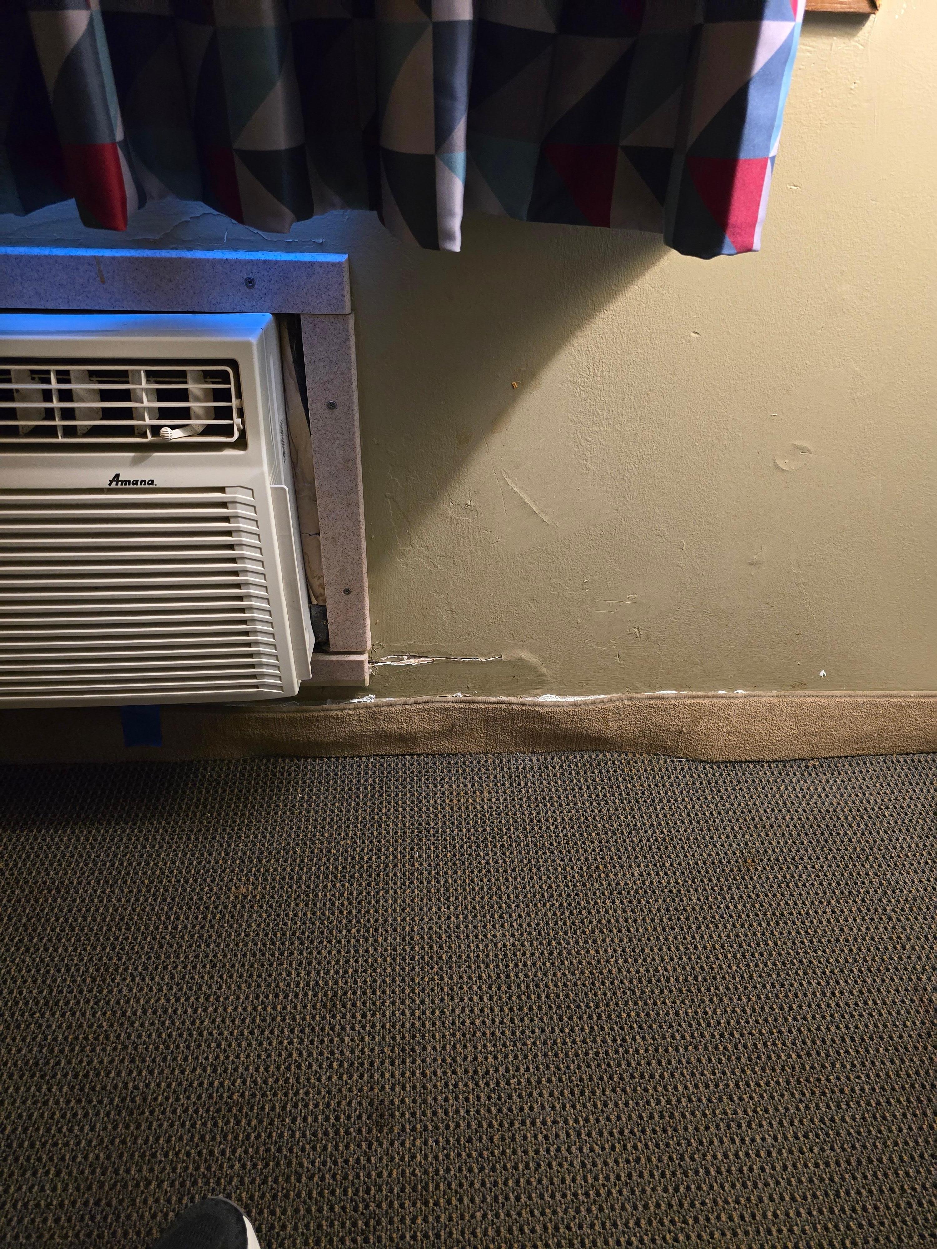Clear evidence of water damage affecting area surrounding the through the wall unit and floorboard