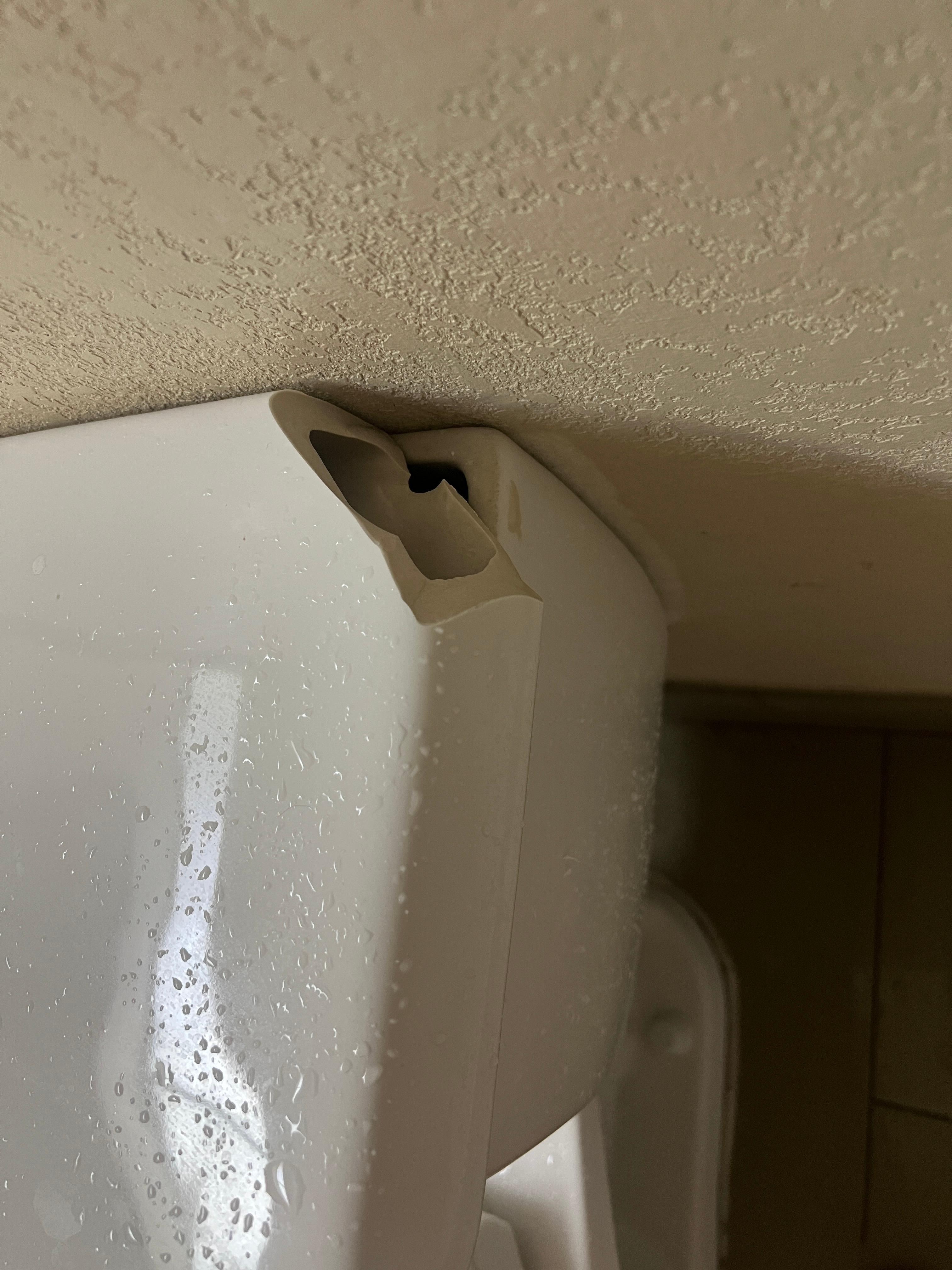Broken toilet tank lid.