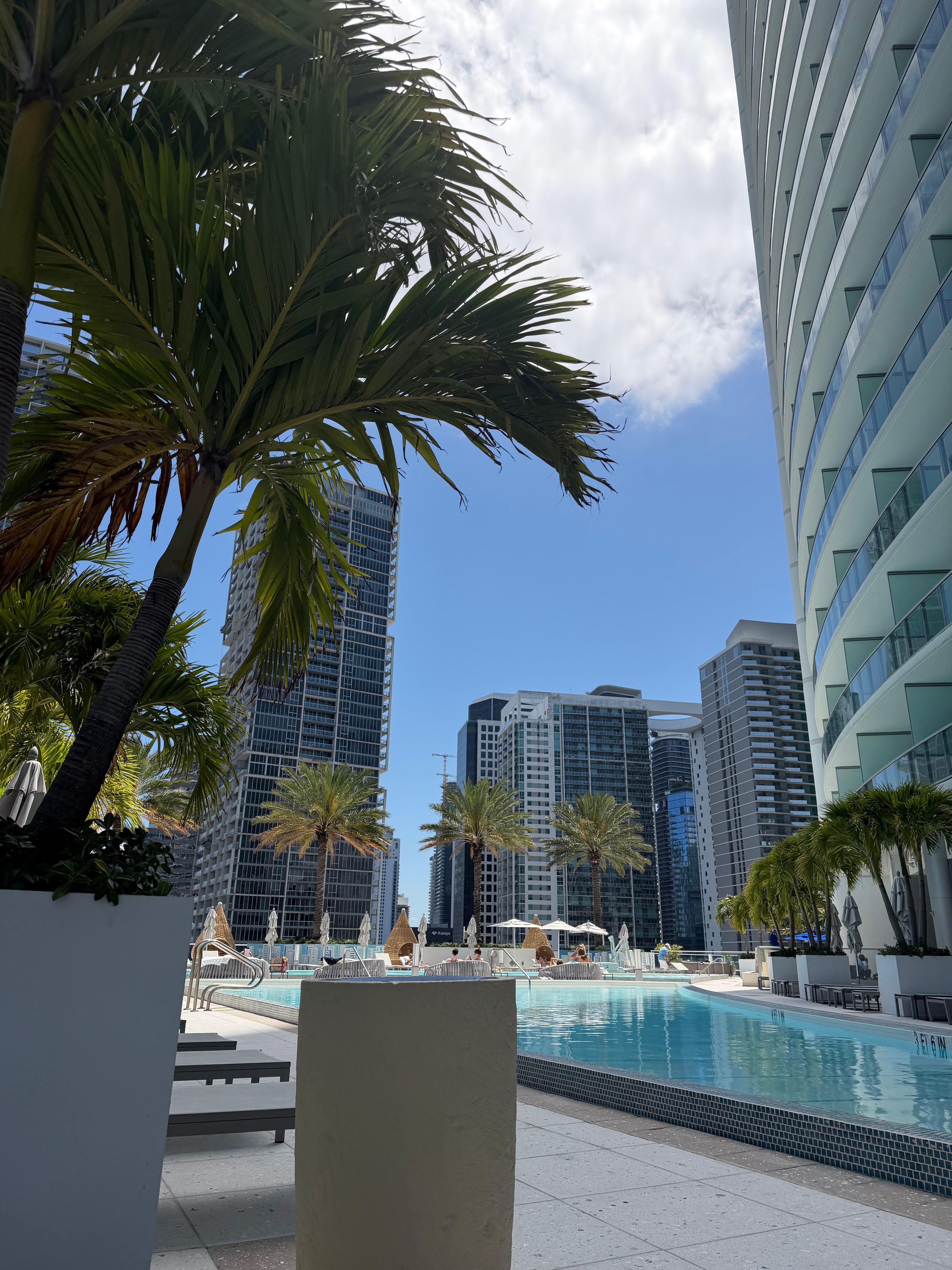 Two pools. A towel/drinks/sunscreen station and a pool-side bar