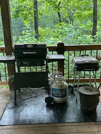 Grill area and grills dirty and covered in ash
