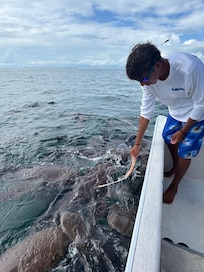 Book a boat tour with Lagi next door to Caye Casa.