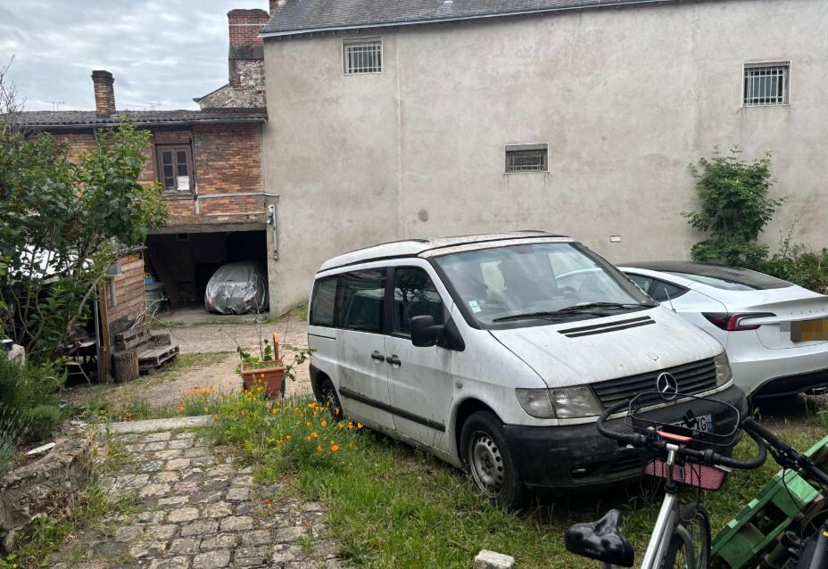 there was room to park your car, the white bus is owned by the owner, but was full of junk.