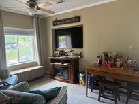 Large screen tv and dining table that could seat 4. Very Comfy chairs with ottomans