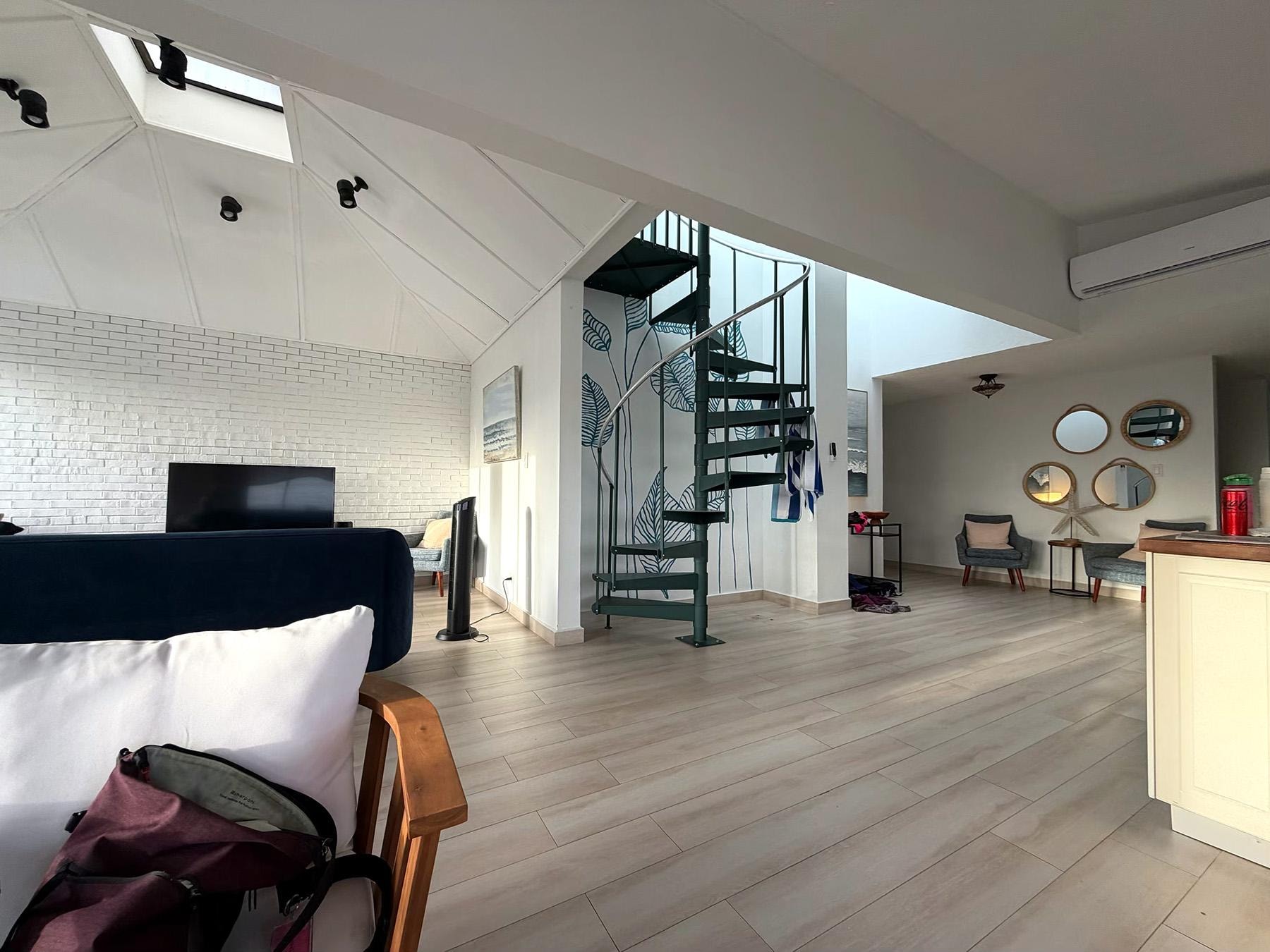 Living room is very comfortable and clean. The stairs are now a metal spiral staircase to the roof.