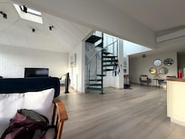Living room is very comfortable and clean. The stairs are now a metal spiral staircase to the roof.