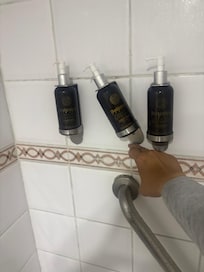 Broken and empty soap and shampoo dispenser