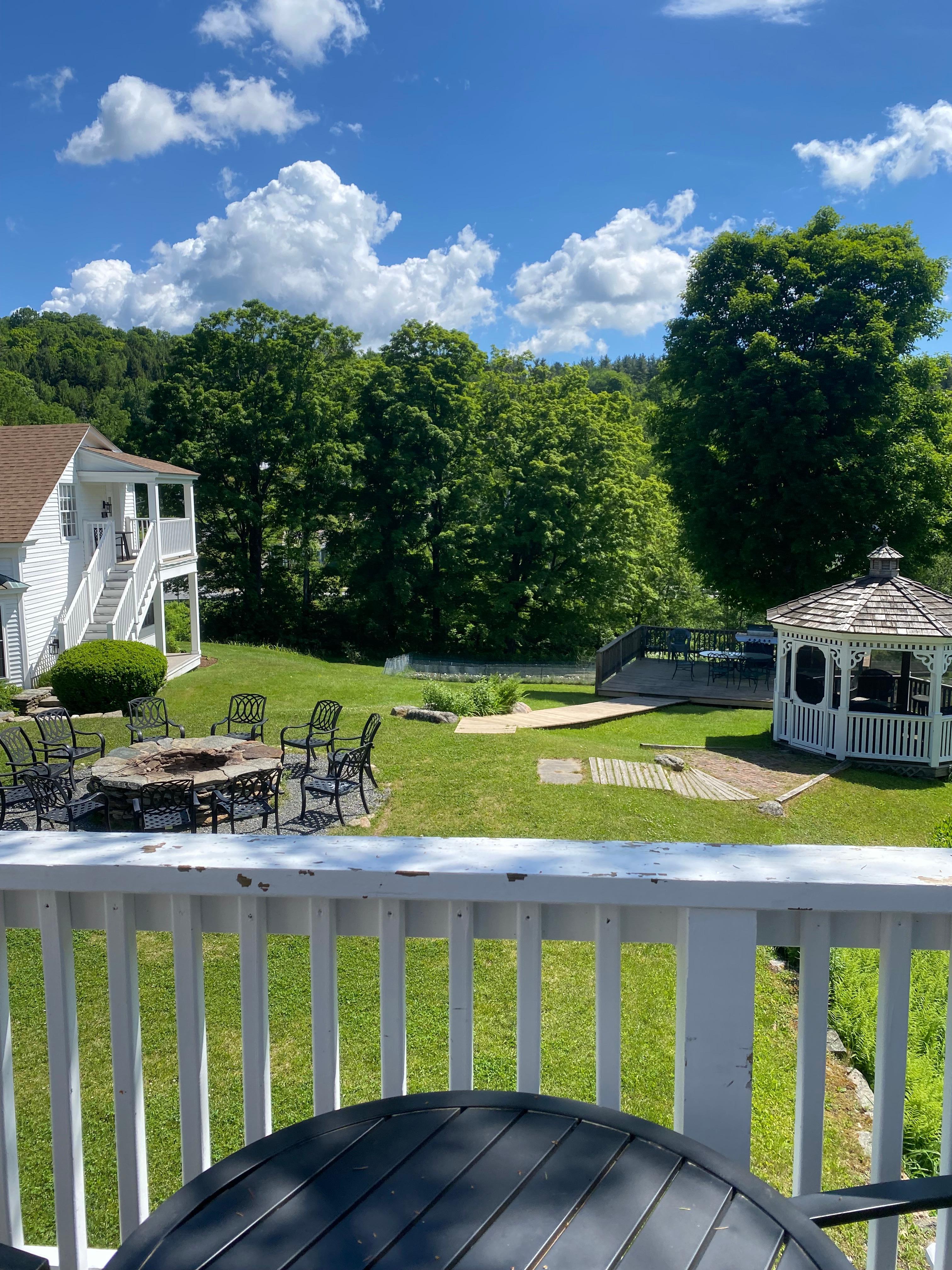 Deck overlooking fire pit and gazebo 