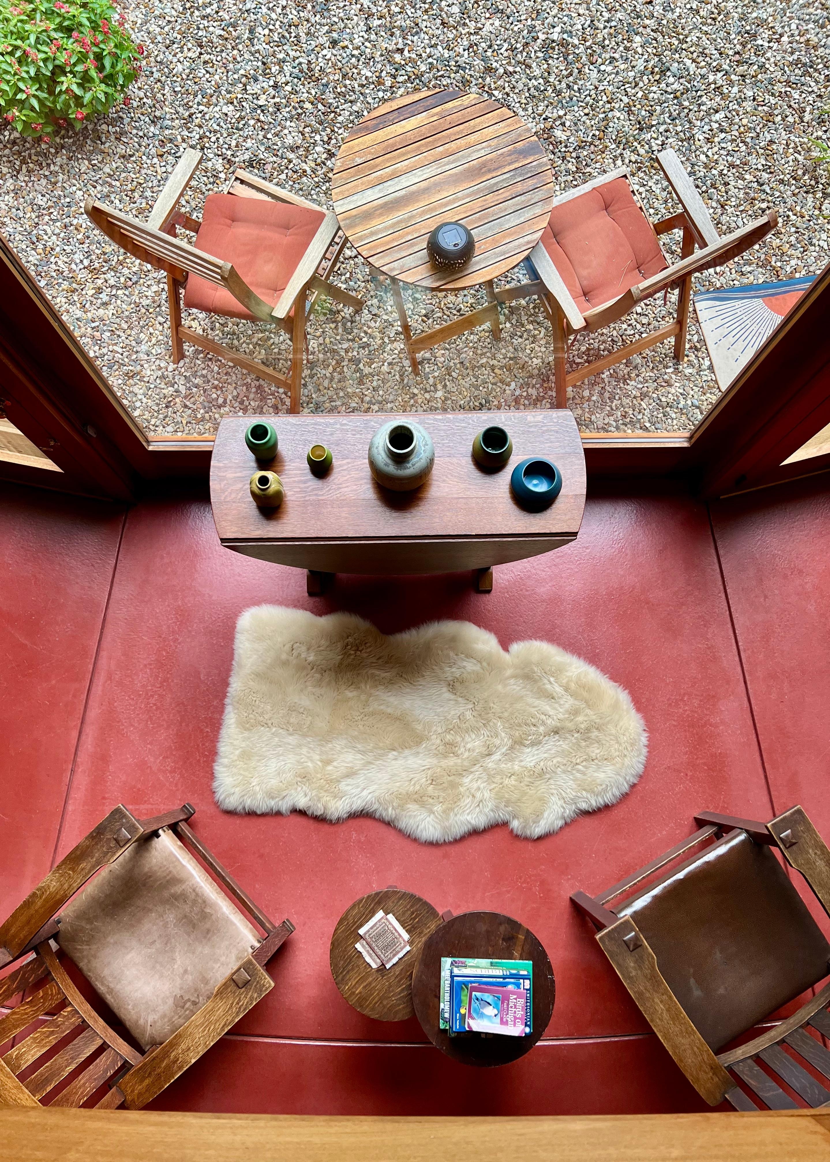 Looking over balcony at living room and outside patio