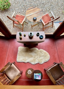 Looking over balcony at living room and outside patio