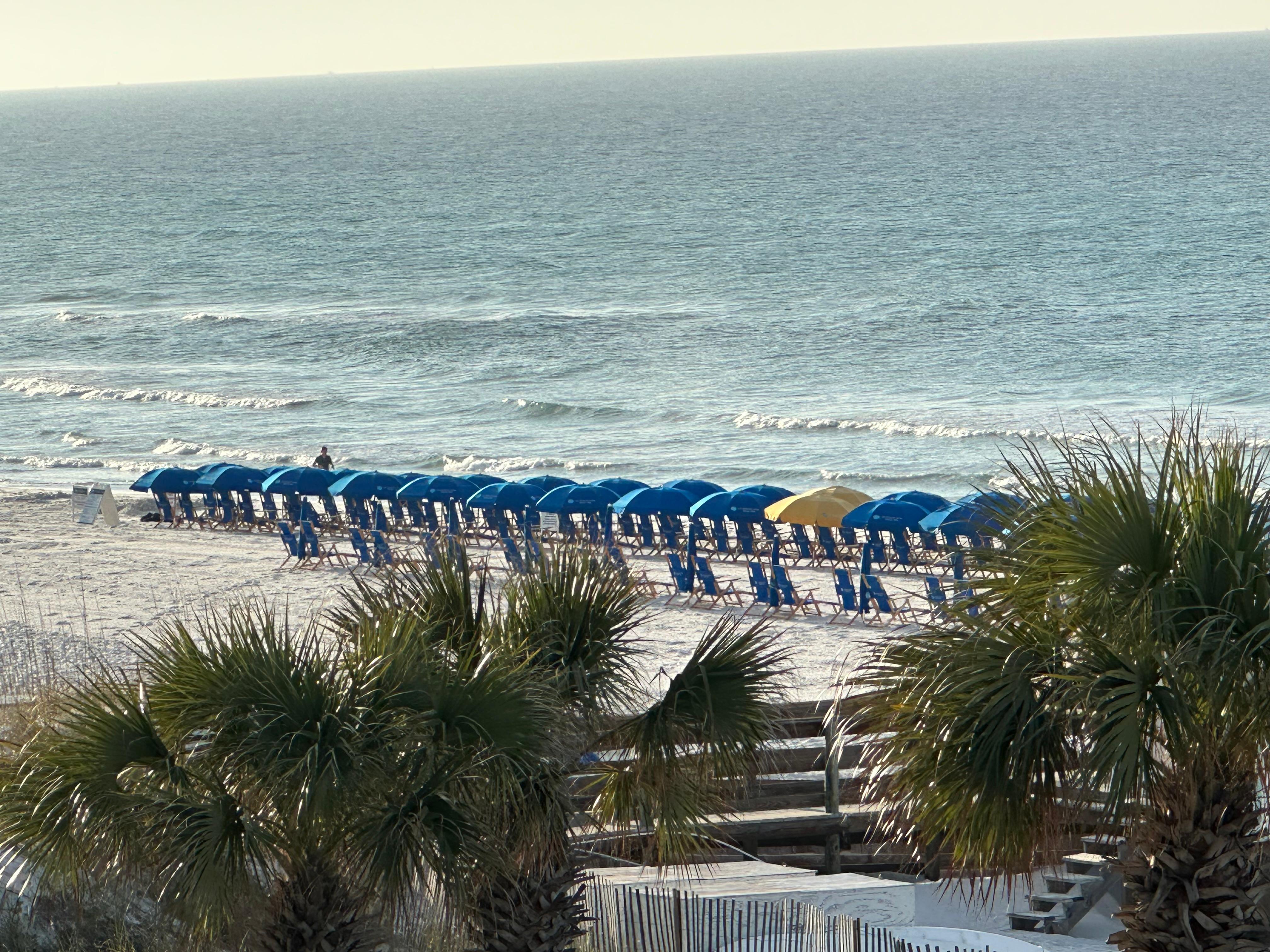 The beach out front with chairs and umbrellas to rent.