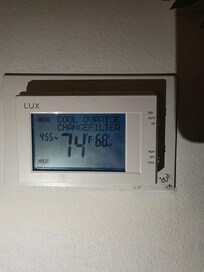 Thermostat showing air set on 68 and temp in house at 74