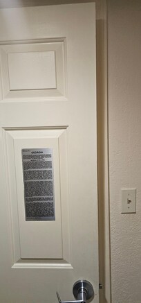 Trying to close door of bathroom.