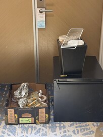 Trash and broken fridge outside our suite door.