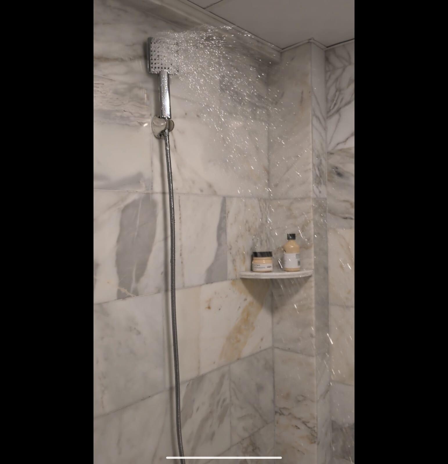 Broken shower head which gets straight when turned on