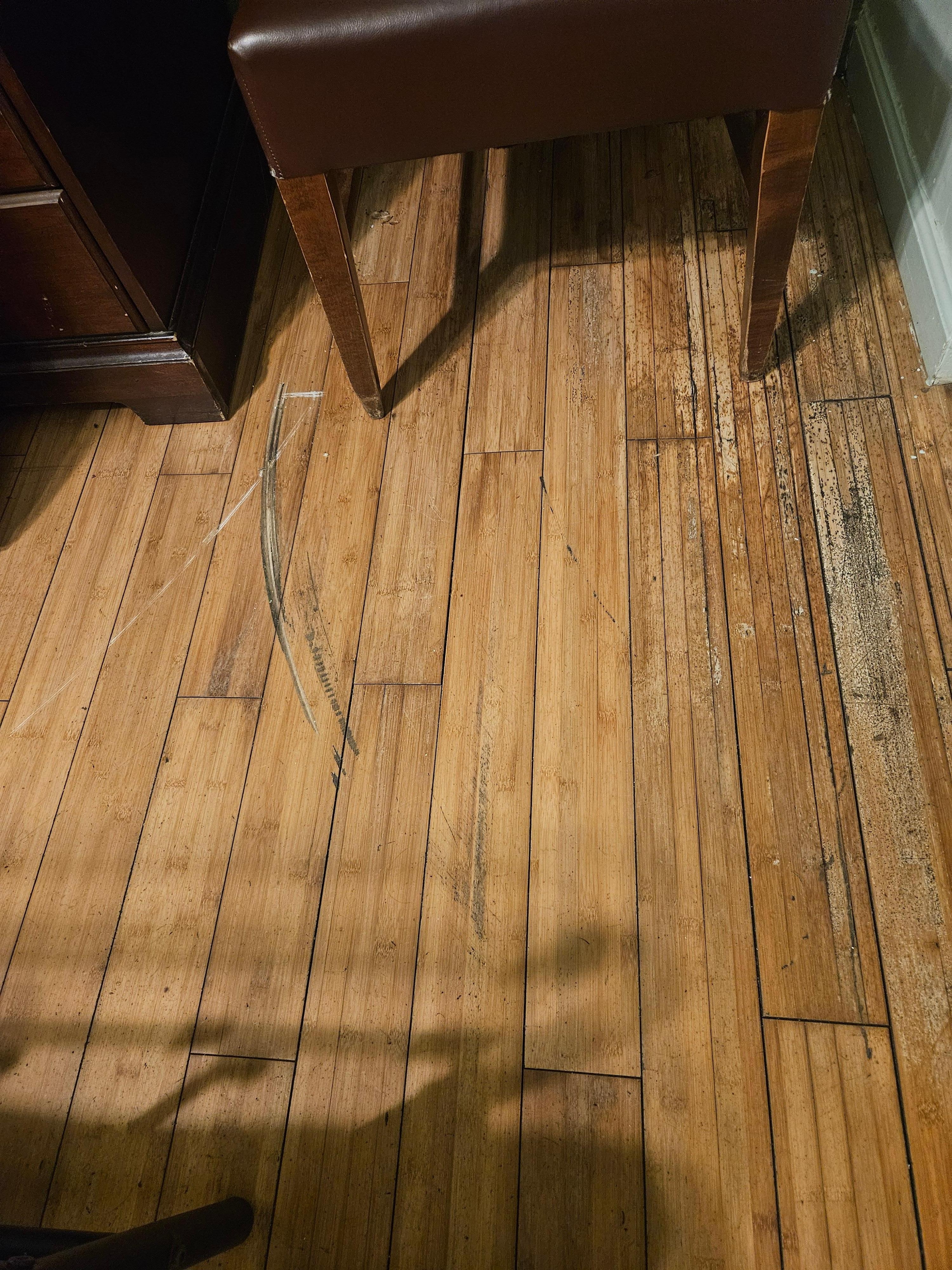 Groove on floor from door being forced open
