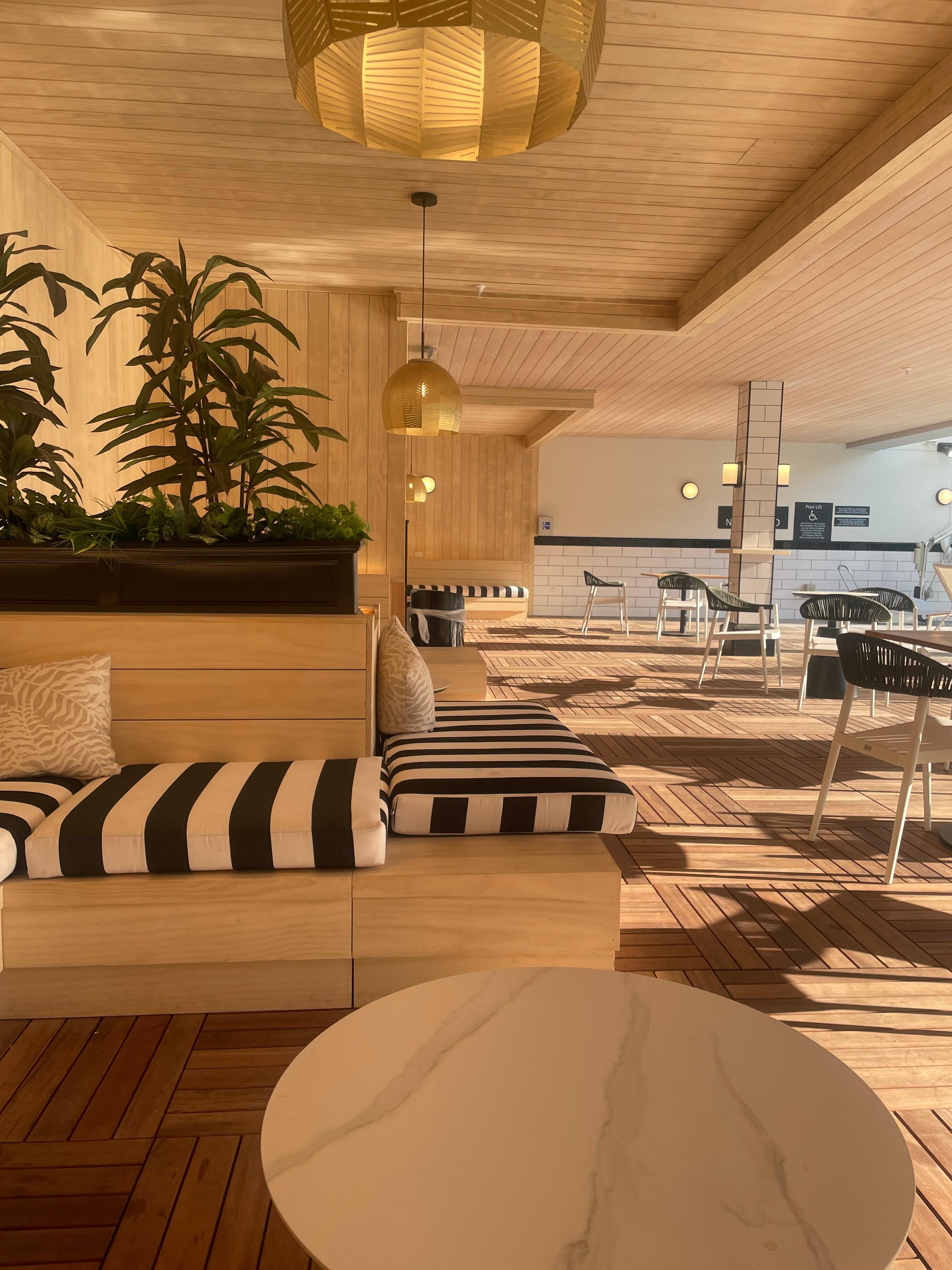 The cute shaded cabana next to the pool, with relaxing pillows and a wall outlet to charge your phone 