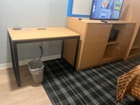 No chair at all. And if you look closely, the TV is literally 'balanced' on the countertop, not yet installed into the wall behind it. It could fall easily.