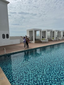 The roof top swimming pool amazing views .