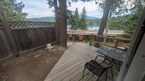 small back deck off the bedroom with the small view of the lake
