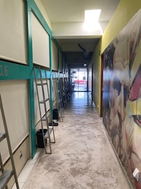 Light at the end of the hall way is the street, to the right are doors to privates