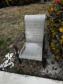 Several cracked and ripped chairs outside