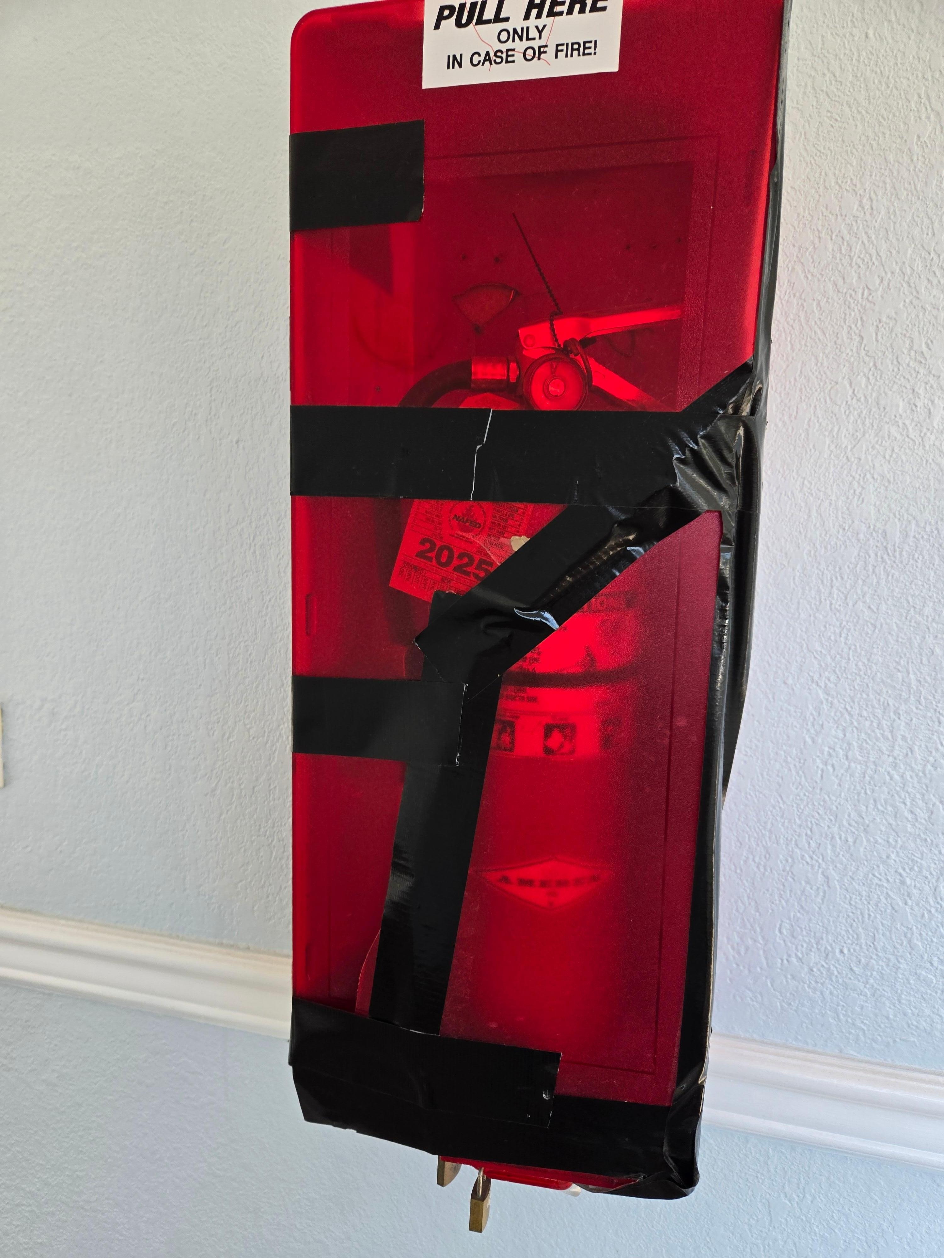The case for the fire extinguisher in the hallway.