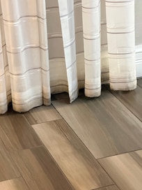 Curtains in entry. White but base by floor filthy.