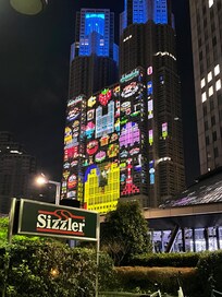 A 500 feet’s away Sizzler with the night light show on the metropolitan building. So Tokyo and lovely!
