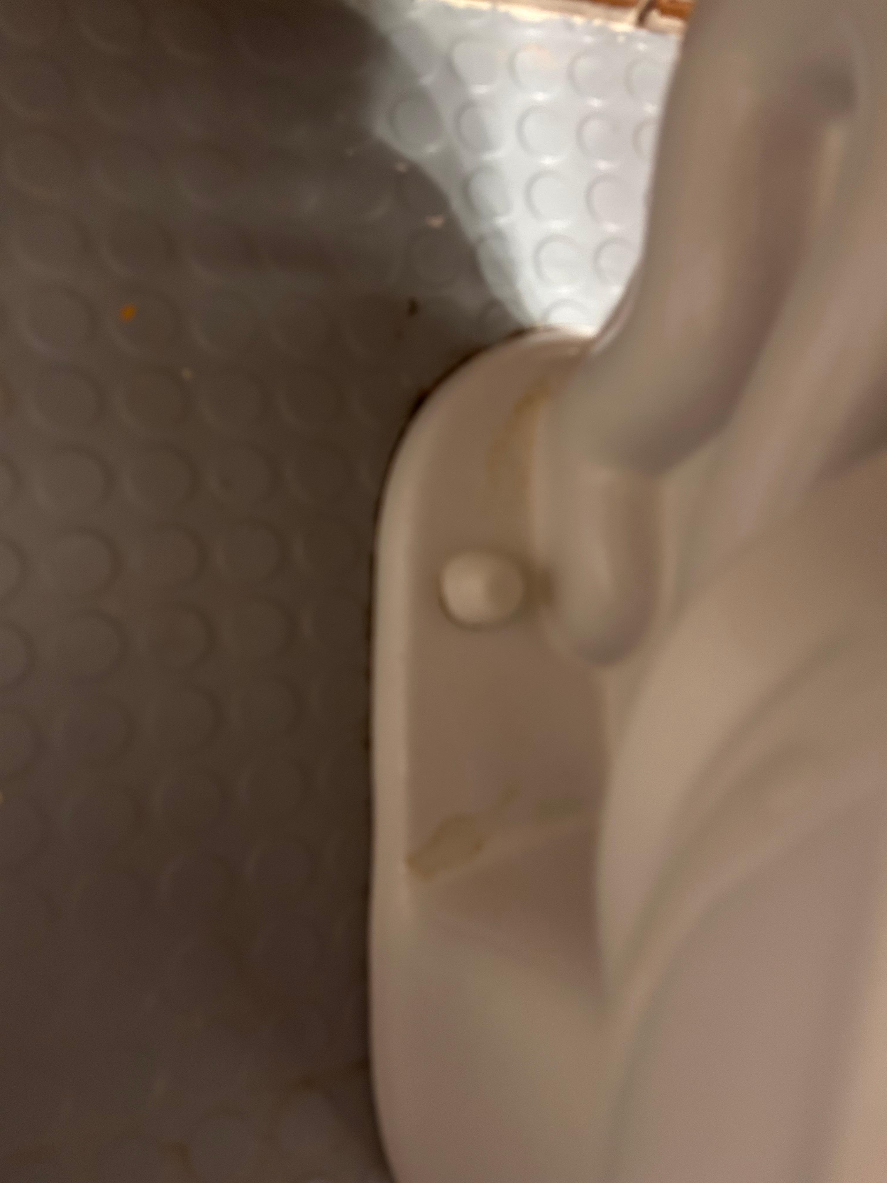 Dried urine on both sides of the toilet