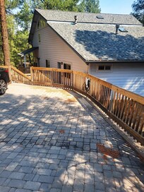 Drive way and Tesla charger on right. driveway does slant downward
